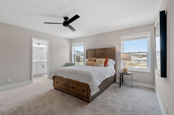 a bedroom with a large bed and a ceiling fan